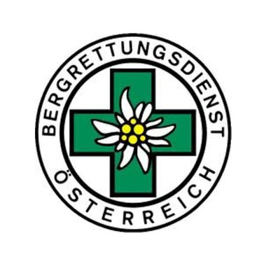 A logo of the Austrian Mountain Rescue Service. It features a green cross with an alpine flower in the center. | © Bergrettung Mittelberg Hirschegg Logo